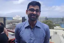 Rahul Sengupta on rooftop overlooking Sydney Harbour at Pounce Marketing