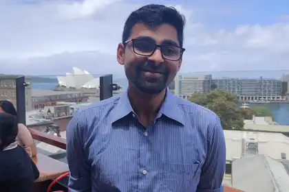 Rahul Sengupta on rooftop overlooking Sydney Harbour at Pounce Marketing